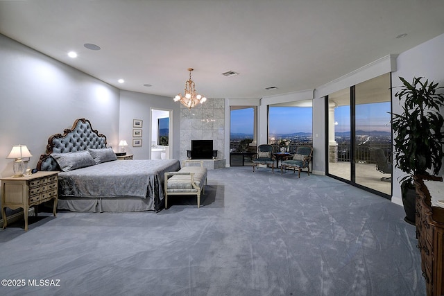 carpeted bedroom with a tiled fireplace, access to exterior, and expansive windows