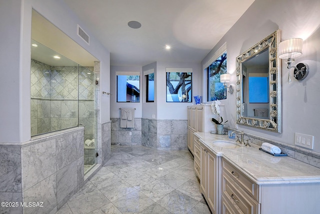 bathroom featuring tile walls, vanity, and tiled shower