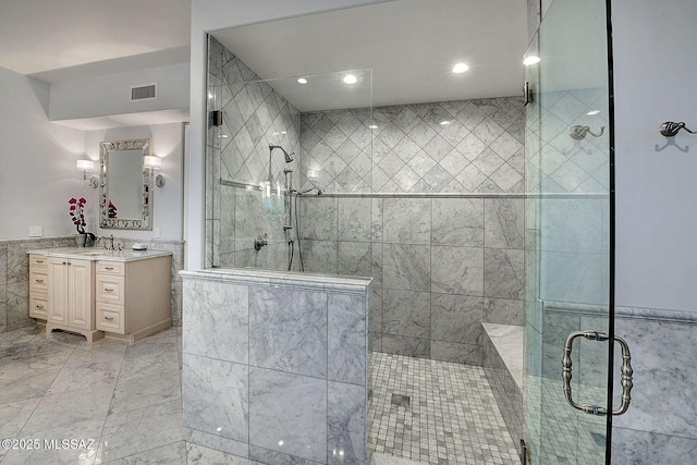 bathroom featuring vanity and an enclosed shower