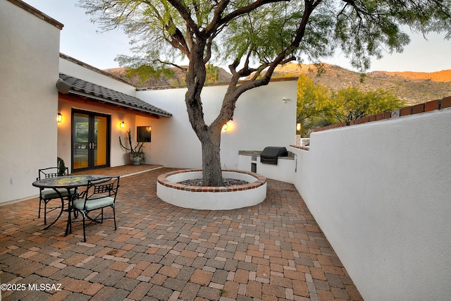 view of patio featuring a mountain view and grilling area