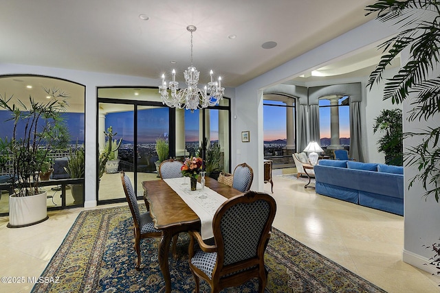 dining space with light tile patterned floors and a chandelier