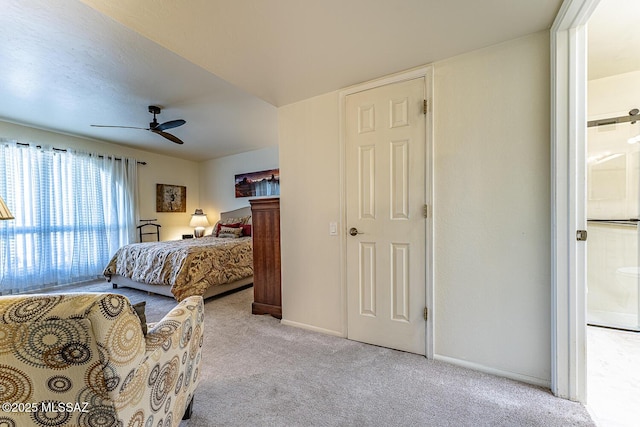 bedroom featuring light colored carpet, baseboards, and ceiling fan