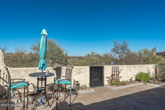 view of patio featuring fence