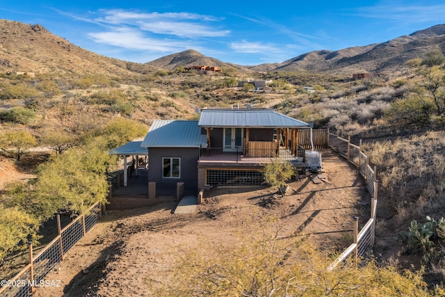 view of front facade with metal roof and a mountain view