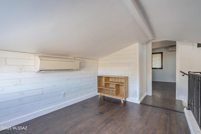 bonus room with vaulted ceiling with beams, dark wood-type flooring, wood walls, an AC wall unit, and a wall mounted AC