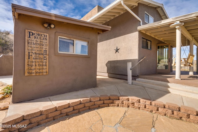 view of side of property featuring a patio area and stucco siding