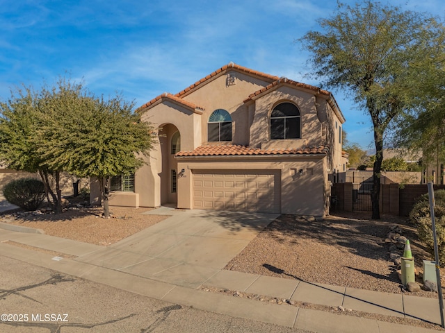 mediterranean / spanish-style home with a garage