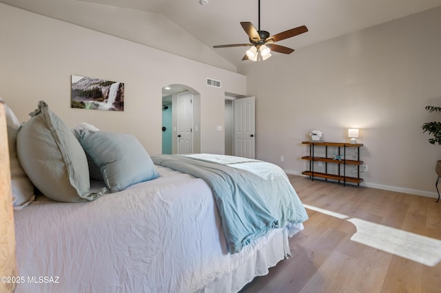 bedroom with wood-type flooring, ceiling fan, and lofted ceiling