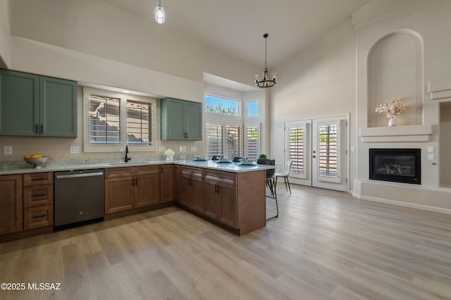 kitchen with light wood-type flooring, sink, pendant lighting, high vaulted ceiling, and dishwasher