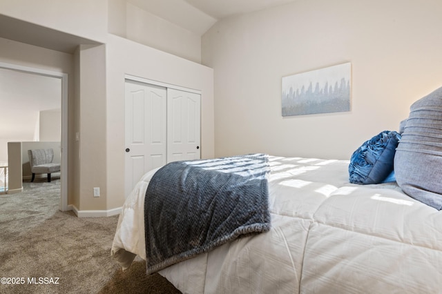 bedroom featuring a closet, carpet, and lofted ceiling