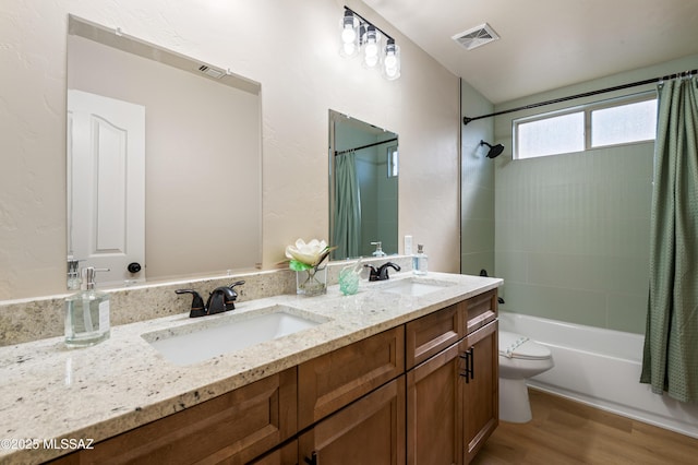 full bathroom featuring hardwood / wood-style floors, vanity, toilet, and shower / bath combo with shower curtain