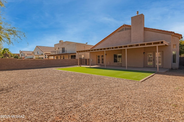 rear view of property featuring french doors