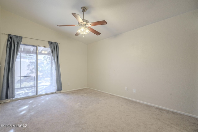 empty room with lofted ceiling, baseboards, a ceiling fan, and light colored carpet