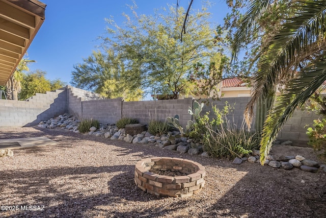 view of yard with an outdoor fire pit and a fenced backyard