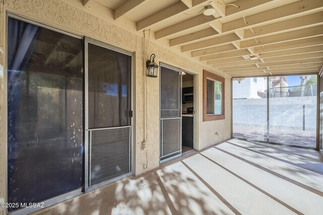 unfurnished living room with ceiling fan, vaulted ceiling, and carpet floors