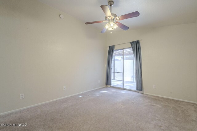 carpeted empty room with ceiling fan and vaulted ceiling