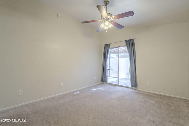 carpeted spare room featuring a ceiling fan, lofted ceiling, and baseboards