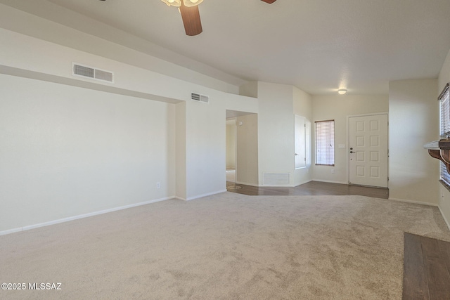 unfurnished room featuring baseboards, visible vents, and carpet flooring