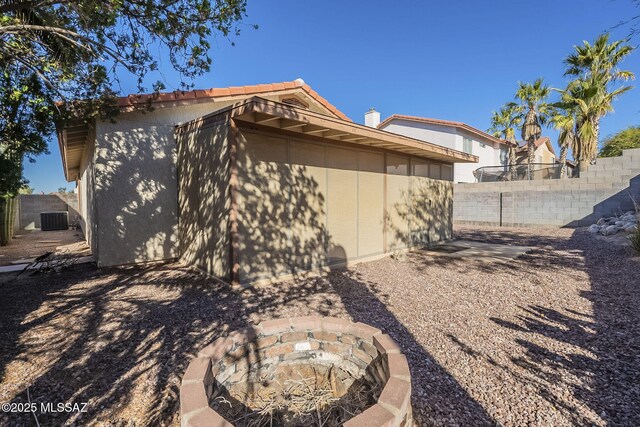 view of side of home featuring a fire pit