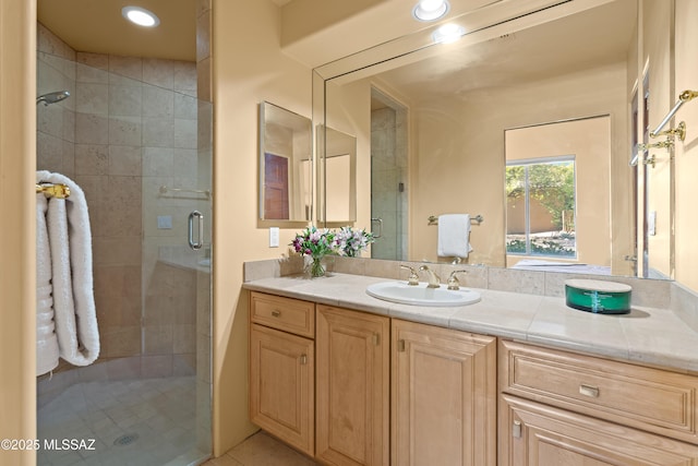 bathroom with vanity, recessed lighting, and a stall shower