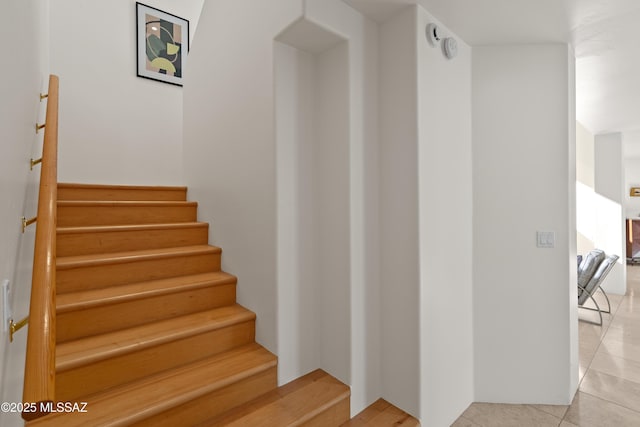 stairs featuring tile patterned floors