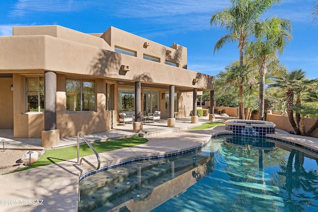 view of swimming pool featuring a patio area, a pool with connected hot tub, and fence