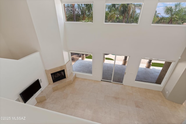 6872 E Desert Wind Ct, Tucson, AZ 85750 - entryway with a tiled fireplace, a towering ceiling, and plenty of natural light