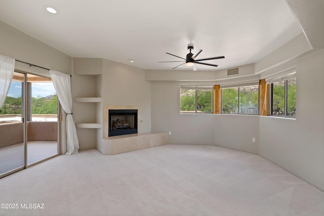 6872 E Desert Wind Ct, Tucson, AZ 85750 - unfurnished living room with a ceiling fan, carpet, built in shelves, healthy amount of natural light, and recessed lighting