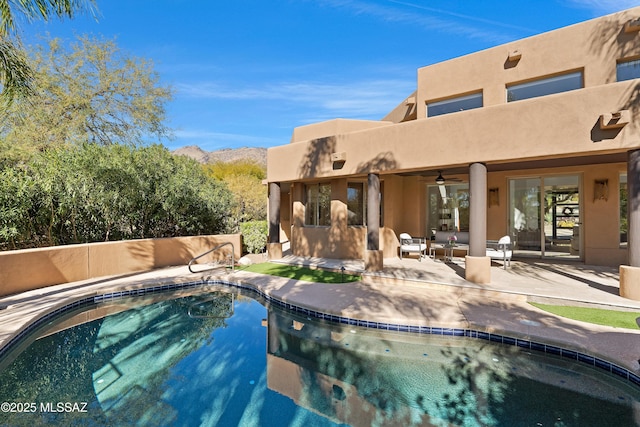 6872 E Desert Wind Ct, Tucson, AZ 85750 - swimming pool with ceiling fan, a patio, an outdoor living space, and a mountain view