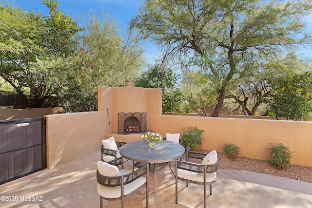 6872 E Desert Wind Ct, Tucson, AZ 85750 - view of patio with an outdoor fireplace and outdoor dining space