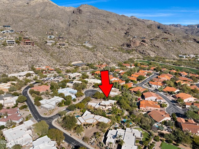 6872 E Desert Wind Ct, Tucson, AZ 85750 - aerial view of property and surrounding area featuring a mountainous background and nearby suburban area