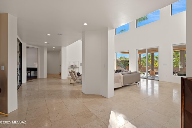 interior space featuring a high ceiling and recessed lighting