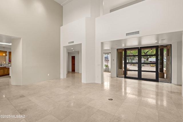 6872 E Desert Wind Ct, Tucson, AZ 85750 - empty room featuring a towering ceiling