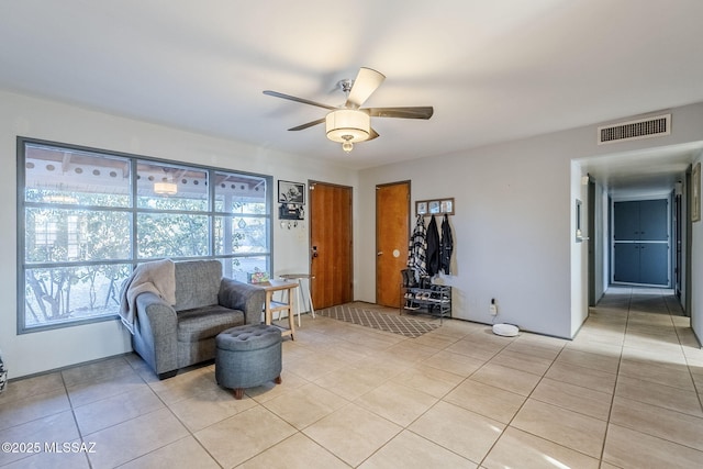 living area featuring ceiling fan and light tile patterned flooring