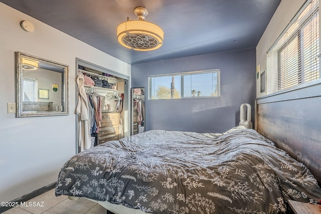 tiled bedroom featuring a closet