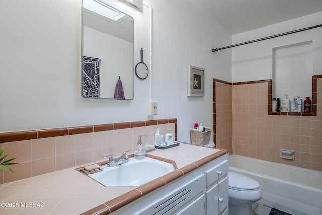 full bathroom with decorative backsplash, vanity, toilet, and tiled shower / bath