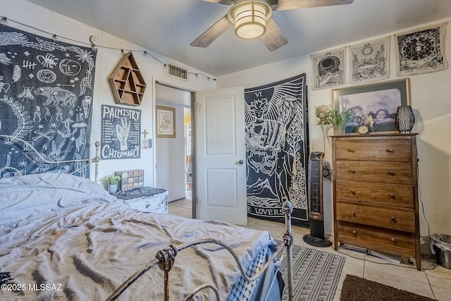 tiled bedroom featuring ceiling fan