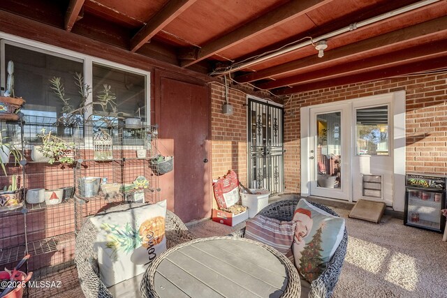 sunroom with beamed ceiling