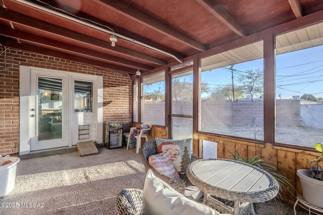 sunroom featuring beamed ceiling and wood ceiling