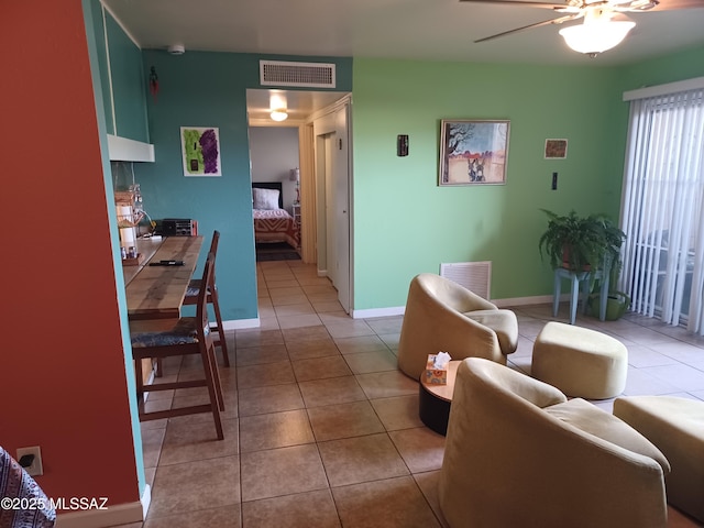 tiled living room featuring ceiling fan