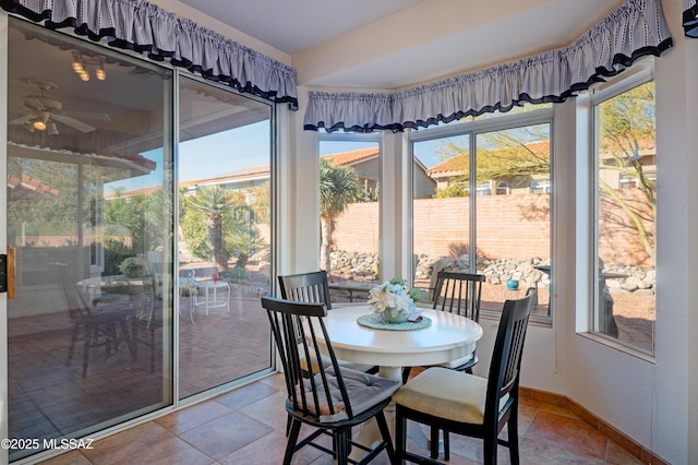 sunroom with ceiling fan and a wealth of natural light