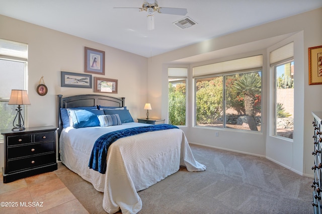 bedroom with ceiling fan and light colored carpet