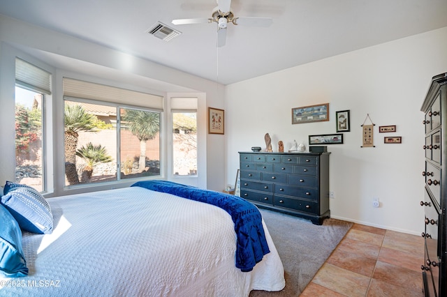 bedroom with ceiling fan and light tile patterned flooring