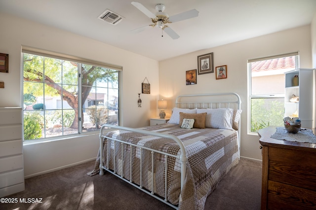 bedroom with ceiling fan and dark carpet