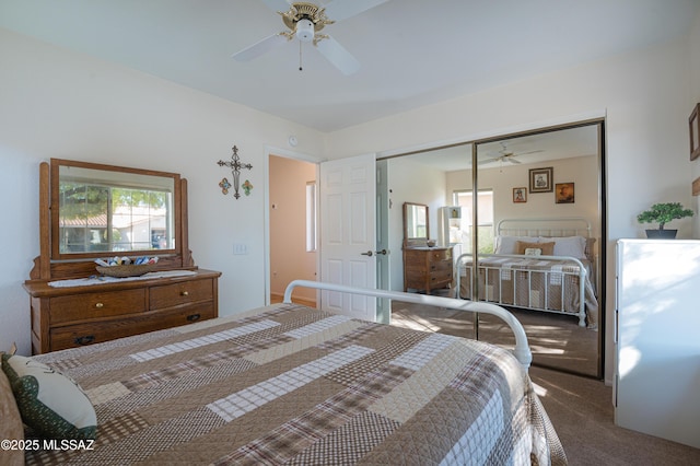 carpeted bedroom with a closet and ceiling fan