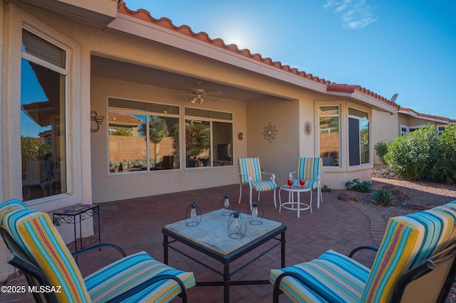 view of patio featuring ceiling fan