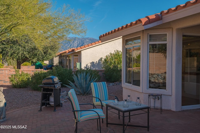 view of patio featuring a mountain view and a grill