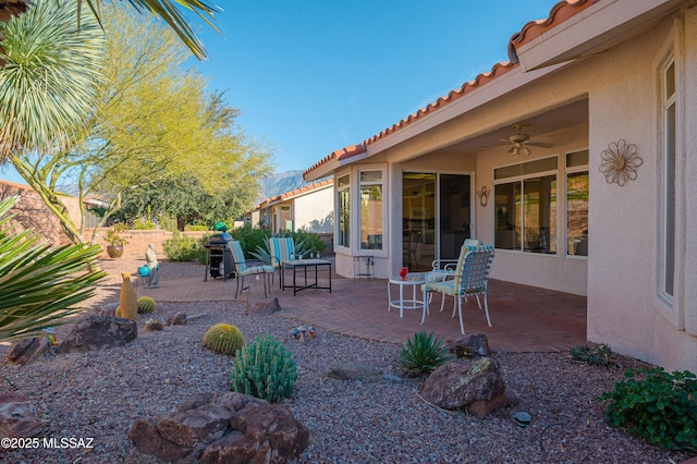 view of patio featuring ceiling fan