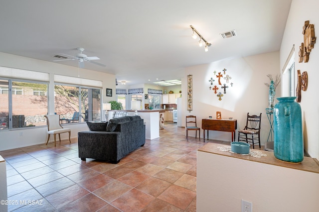 living room featuring ceiling fan and light tile patterned floors