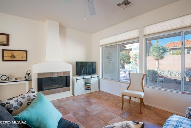 tiled living room with ceiling fan